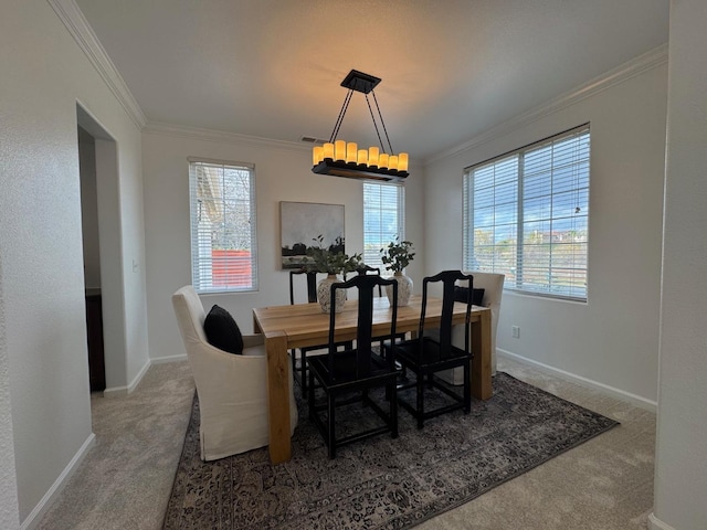 dining room featuring crown molding, carpet, and a wealth of natural light