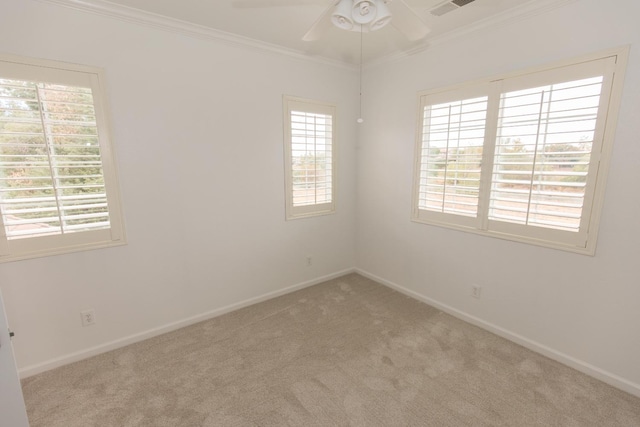 carpeted empty room with ornamental molding, a healthy amount of sunlight, and ceiling fan