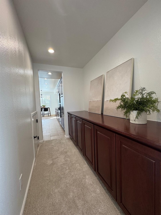 hall with light colored carpet