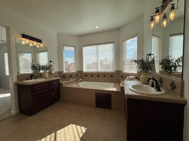 bathroom with vanity, tiled tub, and tile patterned floors