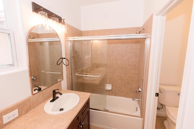 full bathroom featuring vanity, backsplash, enclosed tub / shower combo, and toilet