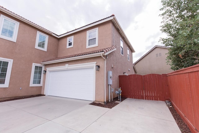 rear view of property featuring a garage