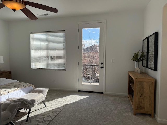 carpeted bedroom featuring access to exterior, a mountain view, and ceiling fan