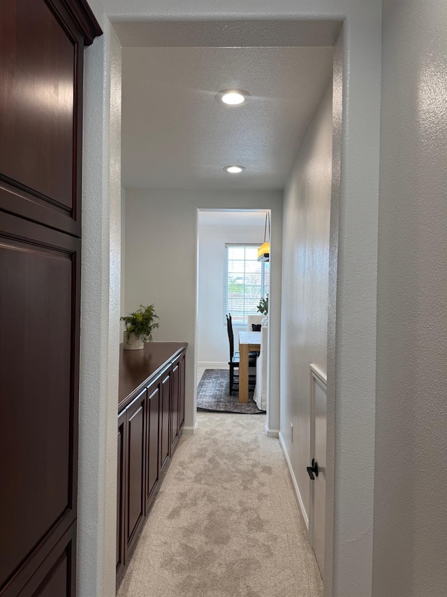 hallway with light carpet