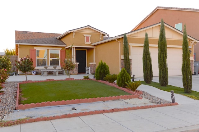 view of front of house featuring a garage and a front lawn