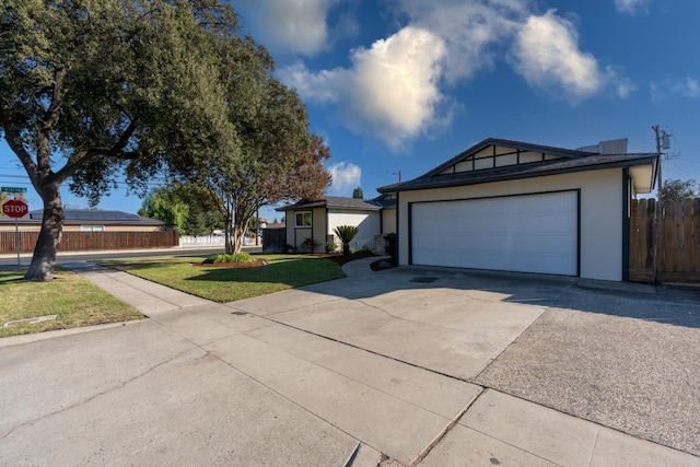 ranch-style home featuring a garage and a front lawn