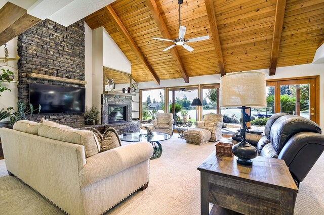 carpeted living room with wooden ceiling, a fireplace, beamed ceiling, ceiling fan, and high vaulted ceiling