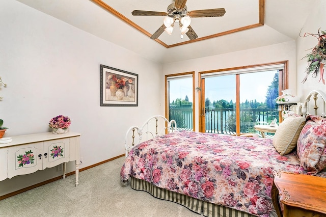 carpeted bedroom with access to outside, ceiling fan, and a water view