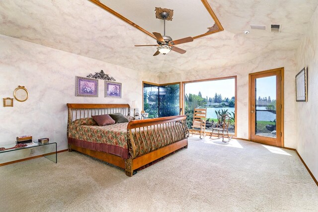 bedroom with carpet, ceiling fan, access to exterior, and a water view