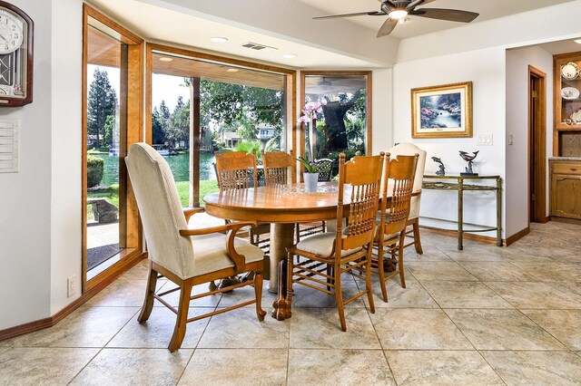 tiled dining area with ceiling fan