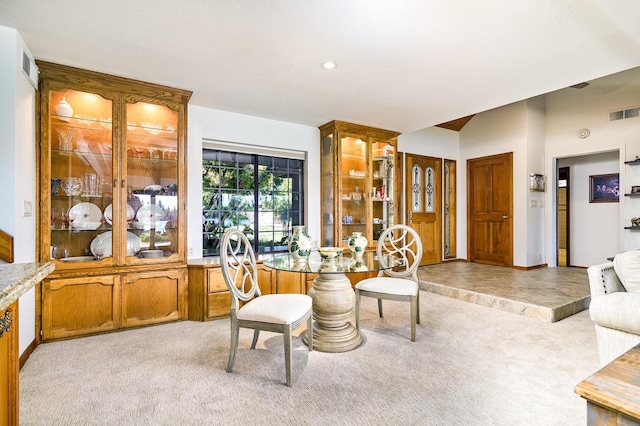 dining area with visible vents, recessed lighting, baseboards, light colored carpet, and vaulted ceiling