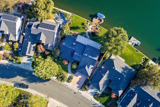 drone / aerial view featuring a residential view and a water view