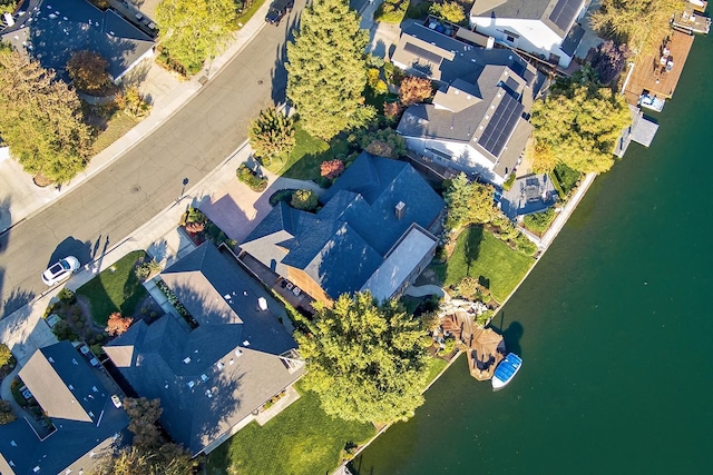 drone / aerial view featuring a residential view and a water view