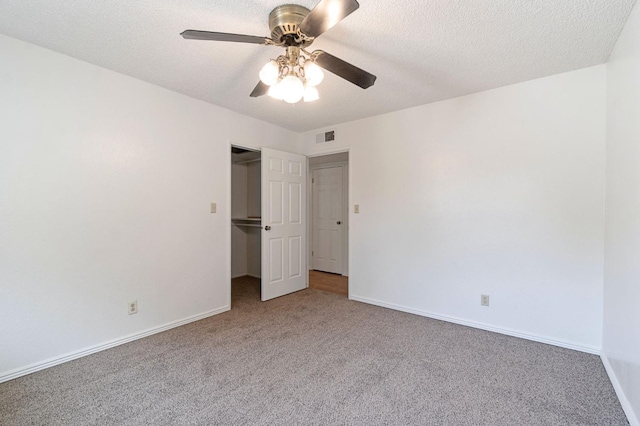 unfurnished bedroom featuring a closet, ceiling fan, and carpet