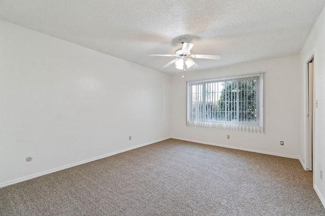 carpeted spare room featuring ceiling fan and a textured ceiling