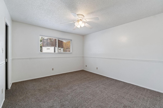 carpeted spare room featuring ceiling fan and a textured ceiling