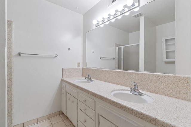 bathroom featuring vanity, tile patterned floors, and a shower with door