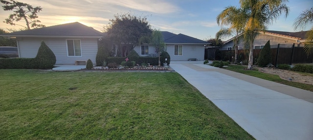 ranch-style home with a yard