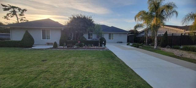 ranch-style home with a yard