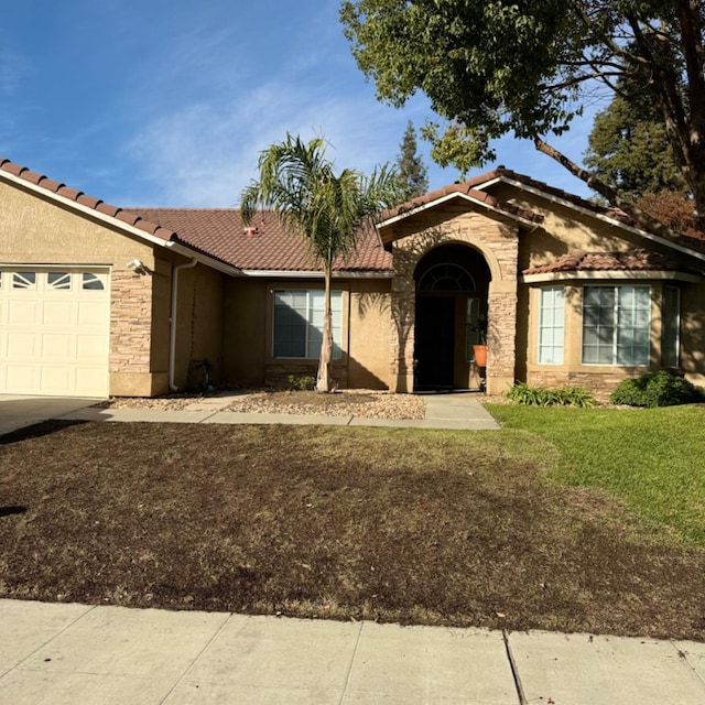 single story home featuring a garage and a front lawn