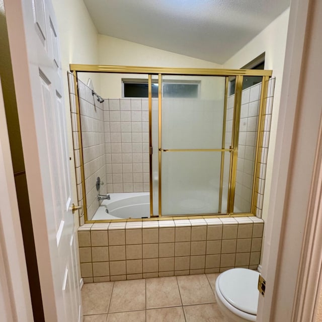 bathroom with a textured ceiling, bath / shower combo with glass door, vaulted ceiling, tile patterned flooring, and toilet