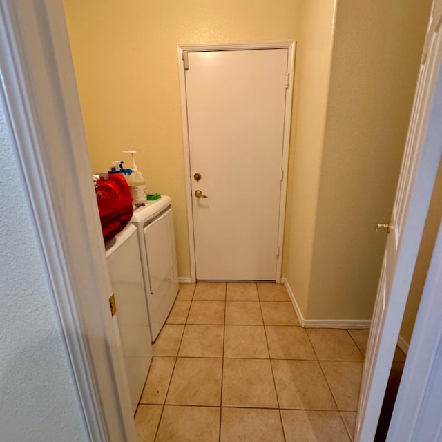 laundry area with light tile patterned floors and separate washer and dryer