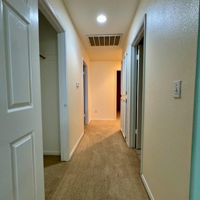 corridor with light colored carpet