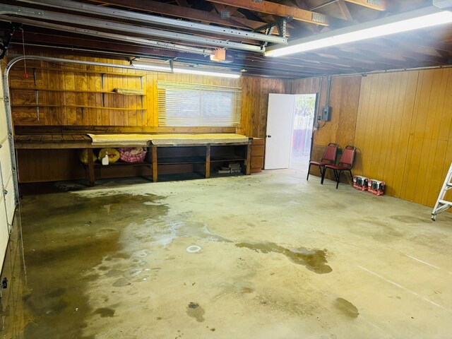 basement with wood walls and a workshop area