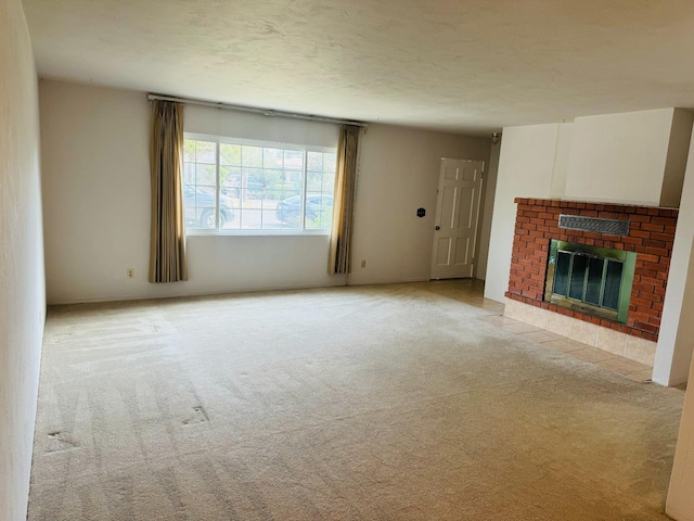 unfurnished living room featuring a brick fireplace and light colored carpet