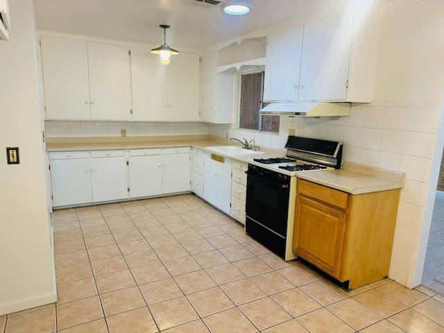 kitchen with white gas range, pendant lighting, sink, tasteful backsplash, and white cabinetry