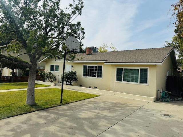 view of front of home featuring basketball court and a front lawn