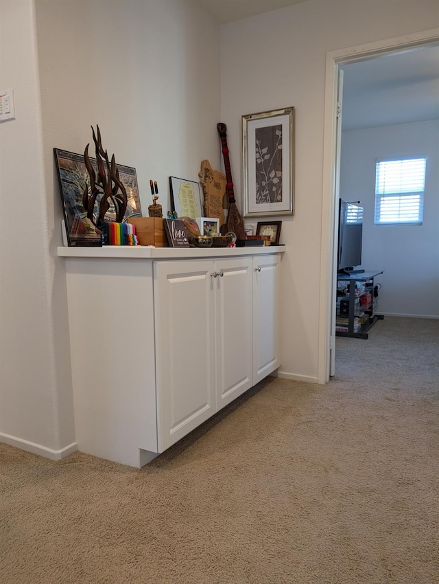 hall featuring light colored carpet