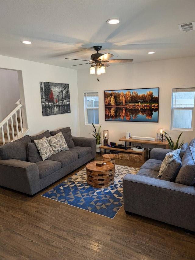 living room featuring ceiling fan, a healthy amount of sunlight, and dark hardwood / wood-style flooring