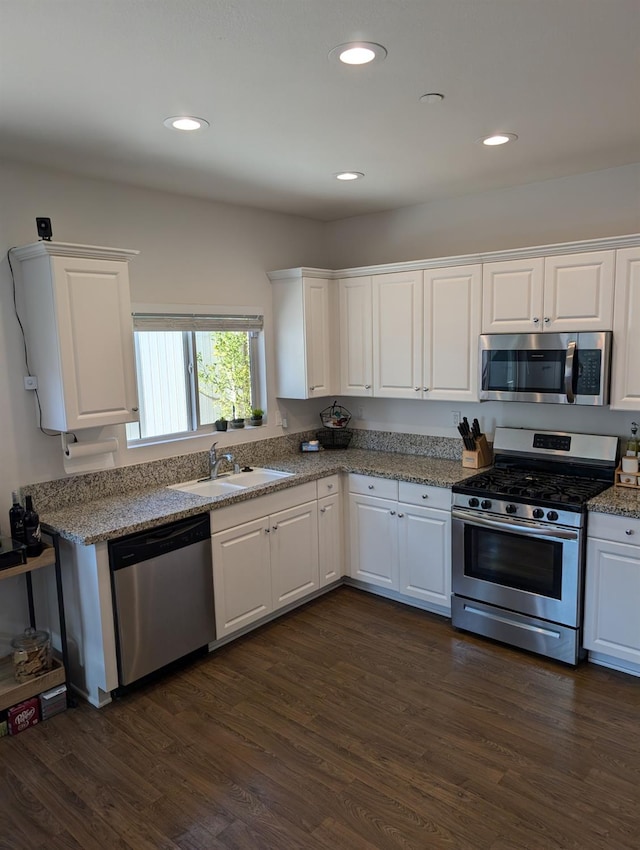 kitchen featuring white cabinets, stainless steel appliances, and dark hardwood / wood-style floors