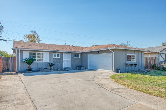 single story home featuring a garage and a front yard