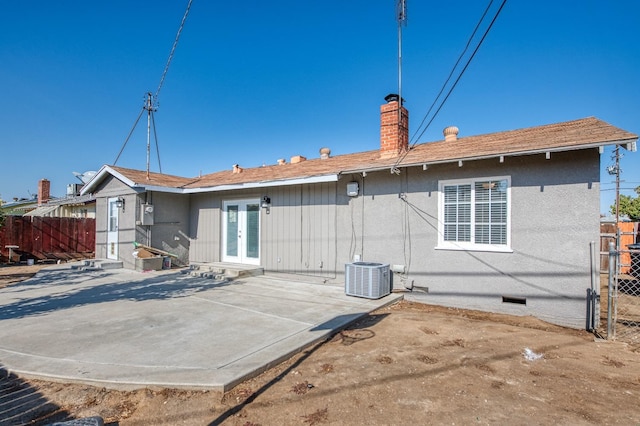 back of property with a patio area and central AC