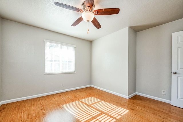 empty room featuring hardwood / wood-style flooring, ceiling fan, and a textured ceiling