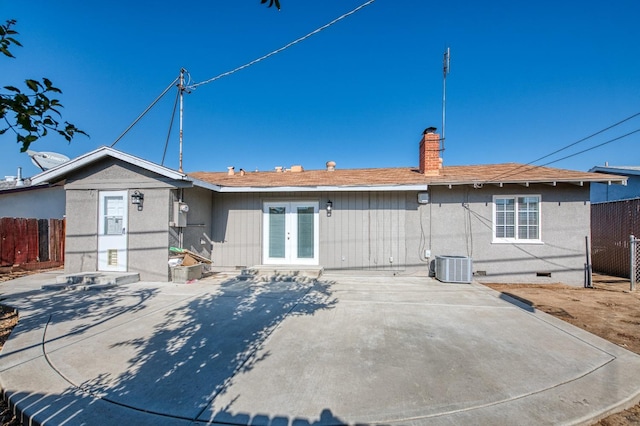 rear view of property with french doors, central AC unit, and a patio area