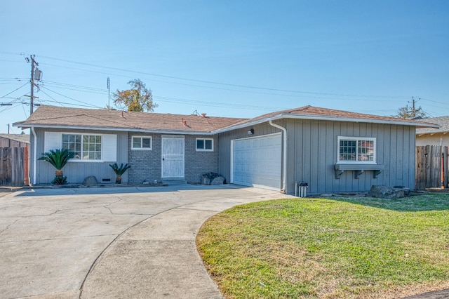 ranch-style home featuring a garage and a front lawn