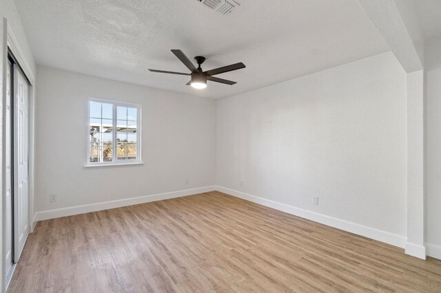 unfurnished bedroom with light wood-type flooring, baseboards, and visible vents