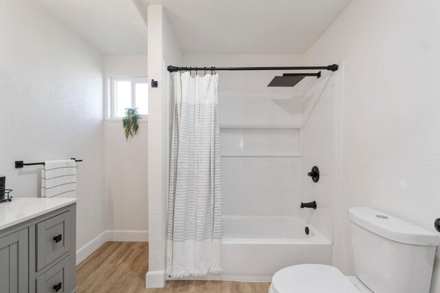 bathroom with shower / tub combo, vanity, toilet, and wood finished floors