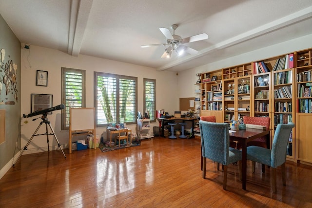 interior space with ceiling fan, beam ceiling, and wood-type flooring