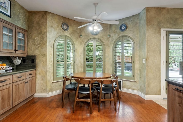 dining space with wood-type flooring and ceiling fan