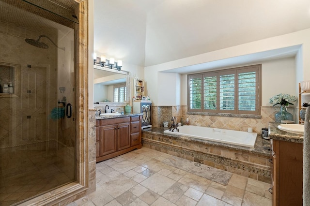 bathroom with vanity and independent shower and bath