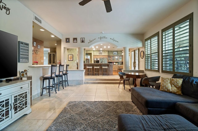 living room featuring ceiling fan and light tile patterned flooring