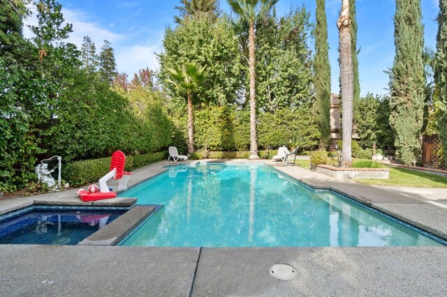 view of swimming pool featuring a patio area