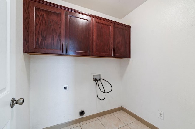 laundry room with cabinets, hookup for a washing machine, light tile patterned floors, and electric dryer hookup