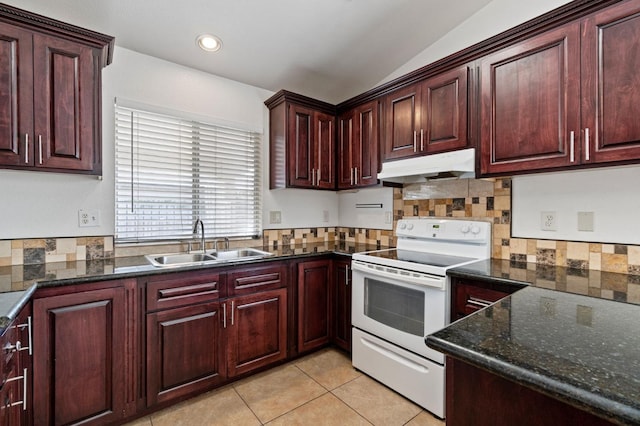 kitchen featuring white range with electric cooktop, vaulted ceiling, sink, light tile patterned floors, and dark stone countertops