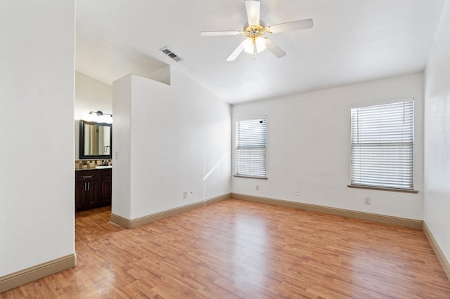 spare room with light hardwood / wood-style flooring, lofted ceiling, and ceiling fan