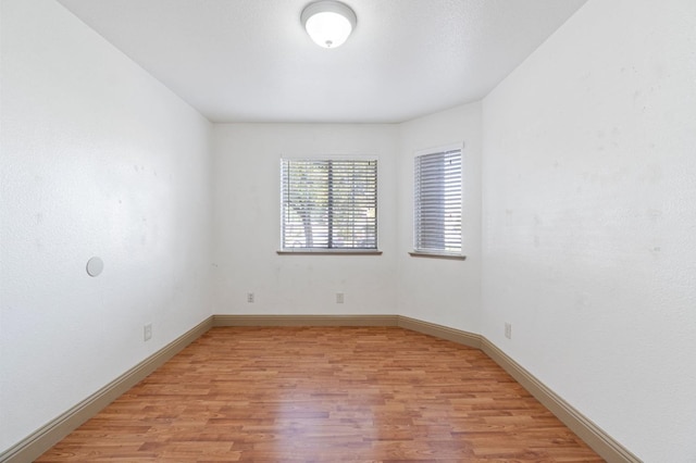 unfurnished room with light hardwood / wood-style floors